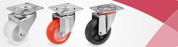 Drie industriële zwenkwielen met witte, rode en zwarte loopvlakken