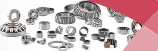 Various metal bearings and plain bearings on white background with red design accent