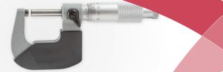 Precision micrometer in close-up on white background with red design accent